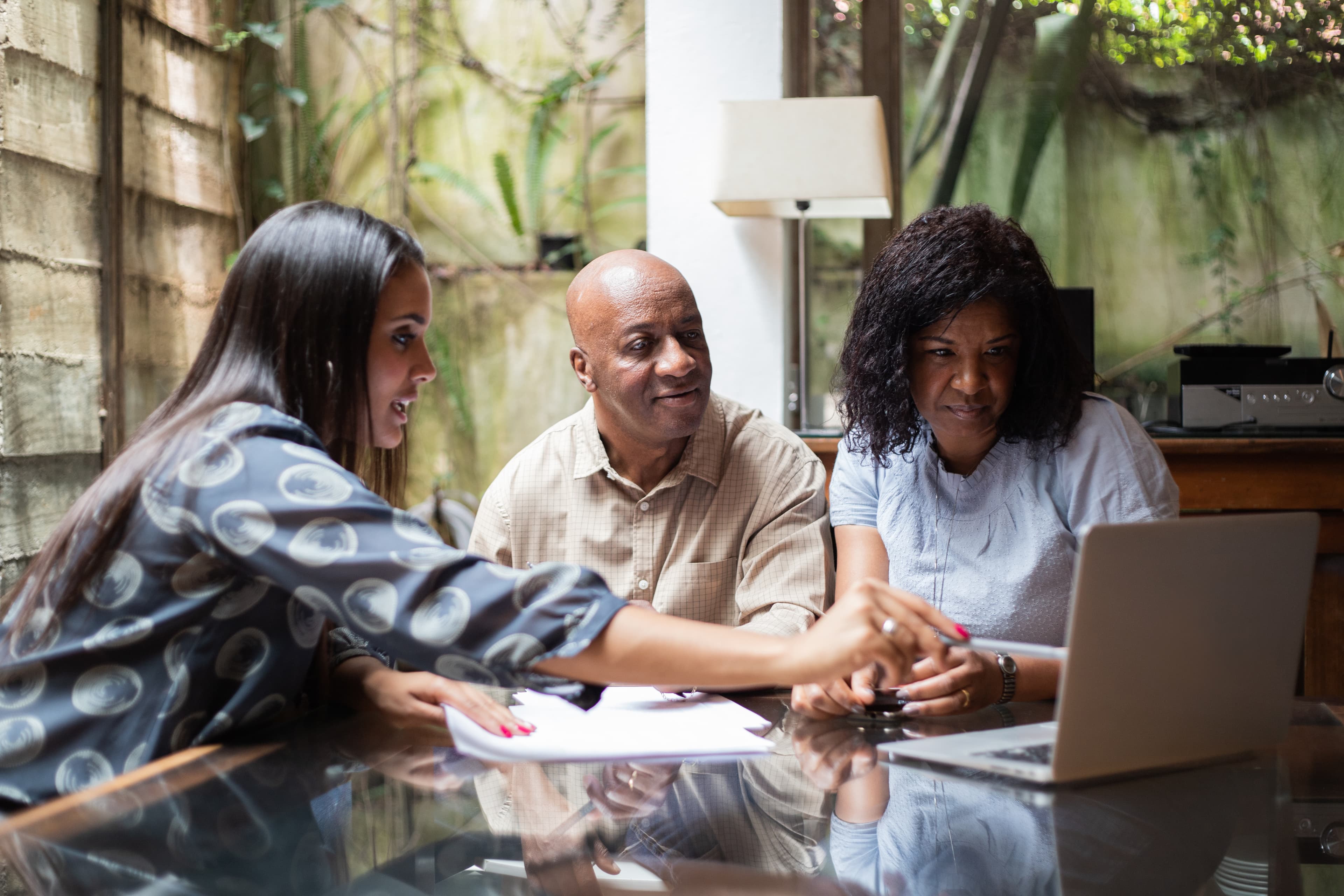 Illustrative picture for the article How to Help Plan Members Navigate Their Finances After Retirement. Picture: Three people looking at a computer screen.