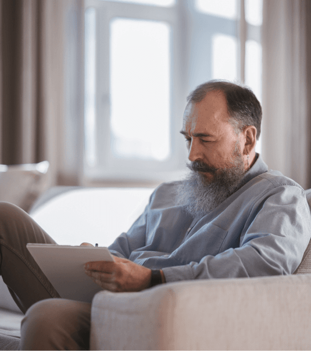 Illustrative picture for the article An income-for-life mutual fund for workplaces . Picture: A man seated and writing.