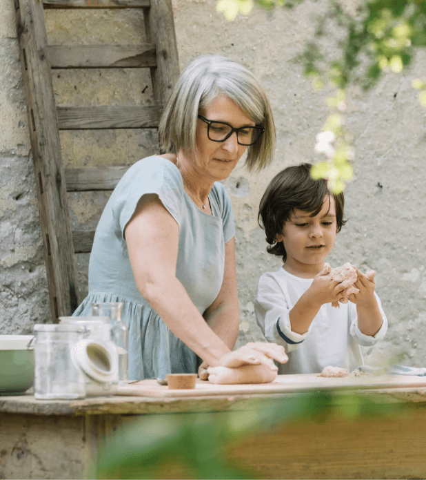 Illustrative picture for the article How Does It Work? A Longevity Pension Fund Theoretical Case Study. Picture: A woman and a kid making dough.